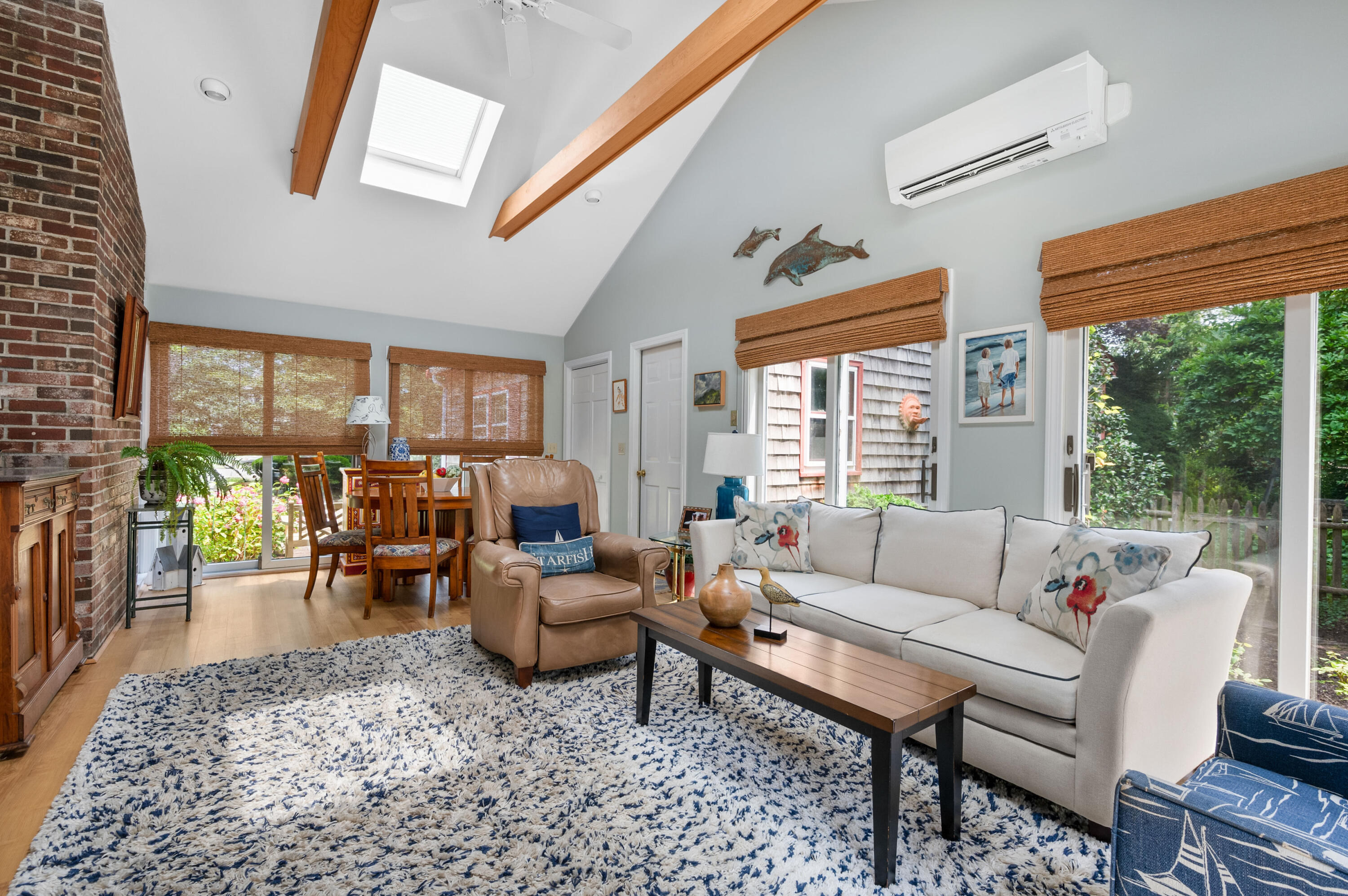 25 Massasoit Trail Eastham, MA 02642 - Photo 12 of 28 a living room with furniture large windows and wooden floor