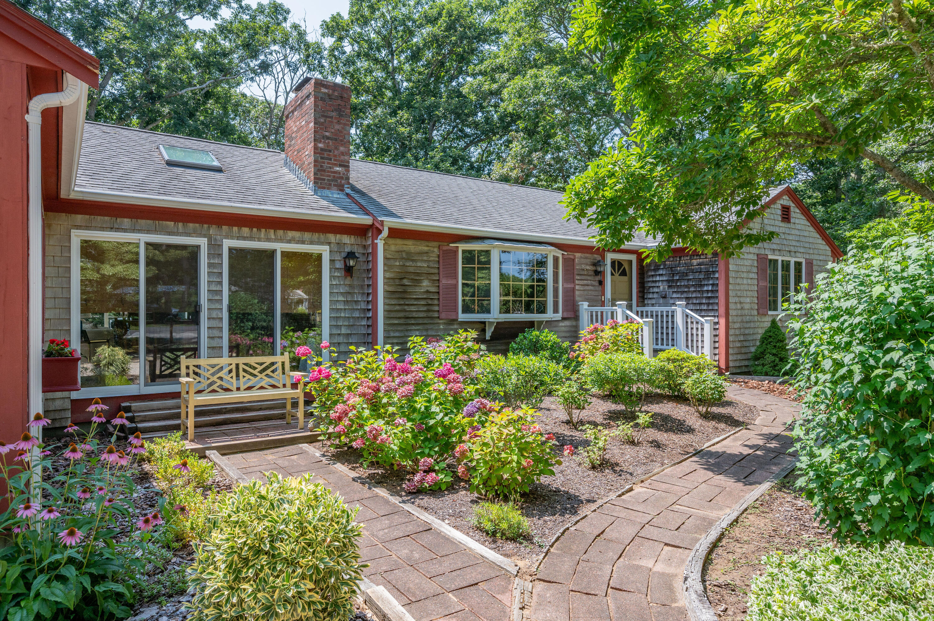 25 Massasoit Trail Eastham, MA 02642 - Photo 2 of 28 a front view of a house with garden