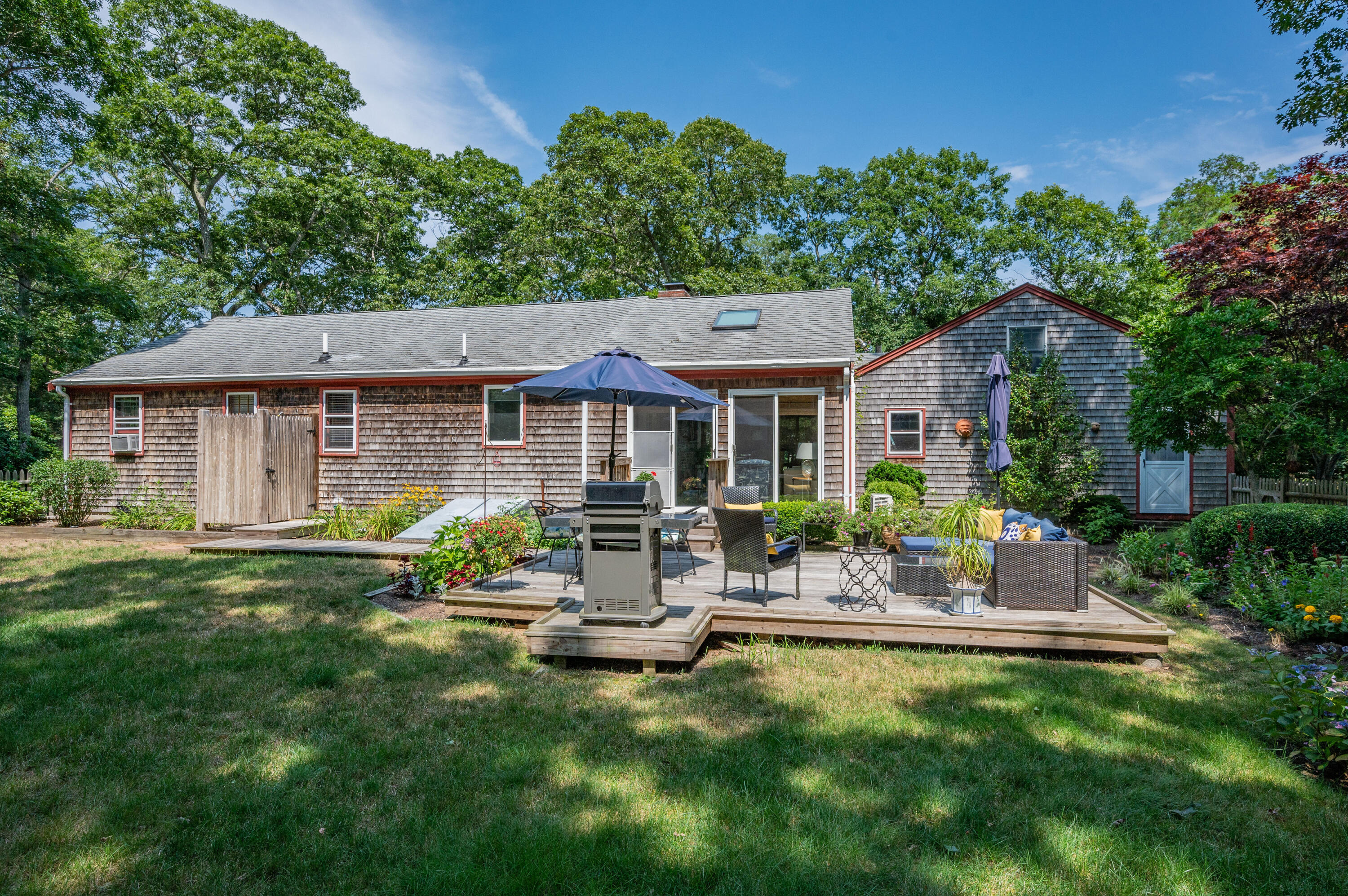 25 Massasoit Trail Eastham, MA 02642 - Photo 26 of 28 a front view of house with yard and outdoor seating