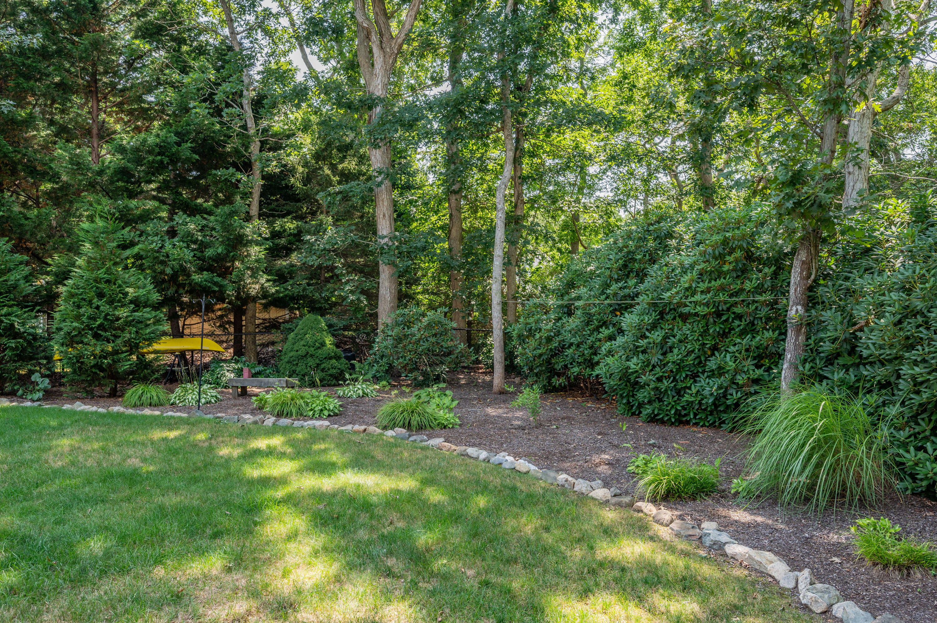25 Massasoit Trail Eastham, MA 02642 - Photo 27 of 28 a view of a backyard with a trees