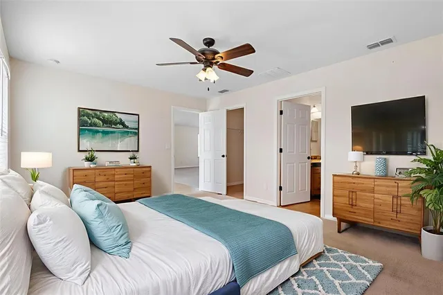 a bedroom with a bed and a flat screen tv