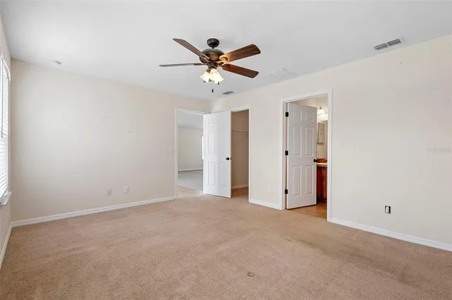 a view of a livingroom with a ceiling fan and window