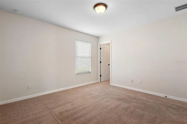 an empty room with windows and closet