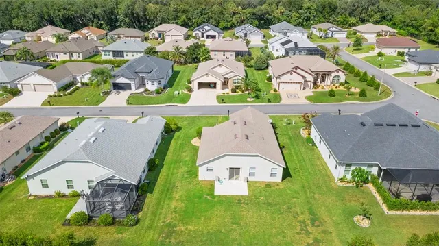 an aerial view of multiple houses with yard