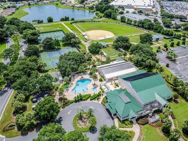 an aerial view of a house with a swimming pool and garden
