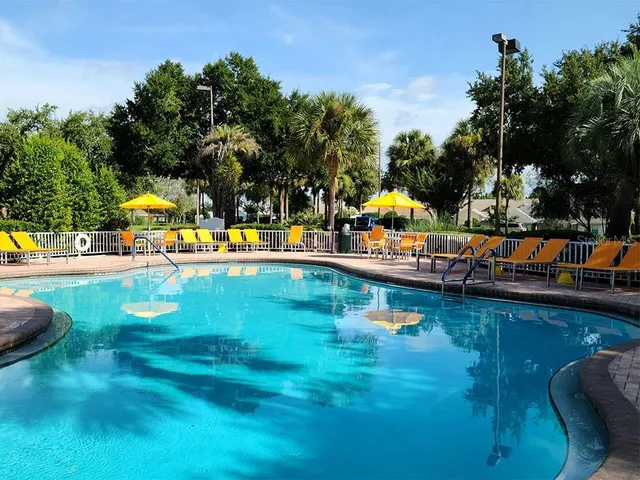 swimming pool view with a garden view