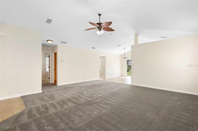 a view of a livingroom with a ceiling fan and window