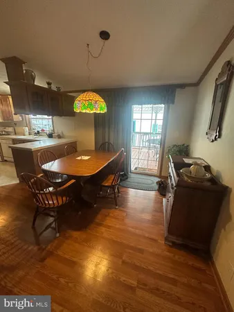 a living room with dining room and wooden floor