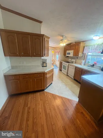 a kitchen with stainless steel appliances granite countertop a sink wooden cabinets and a granite counter top