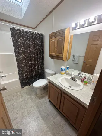 a bed sitting in a bedroom next to a bathroom