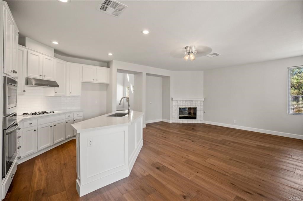 30840 Point Woods Court Temecula, CA 92591 - Photo 11 of 35 a kitchen with stainless steel appliances granite countertop a stove and a refrigerator