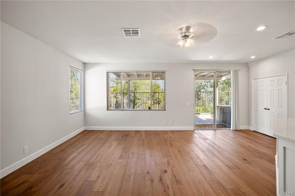 30840 Point Woods Court Temecula, CA 92591 - Photo 14 of 35 an empty room with wooden floor and windows