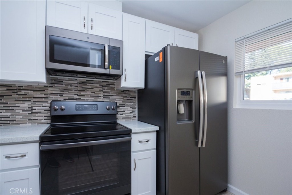 2940 North Verdugo Road, Unit 321 Glendale, CA 91208 - Photo 11 of 38 a kitchen with stainless steel appliances a refrigerator stove and microwave