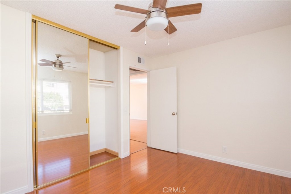 2940 North Verdugo Road, Unit 321 Glendale, CA 91208 - Photo 14 of 38 an empty room with wooden floor cabinet and windows