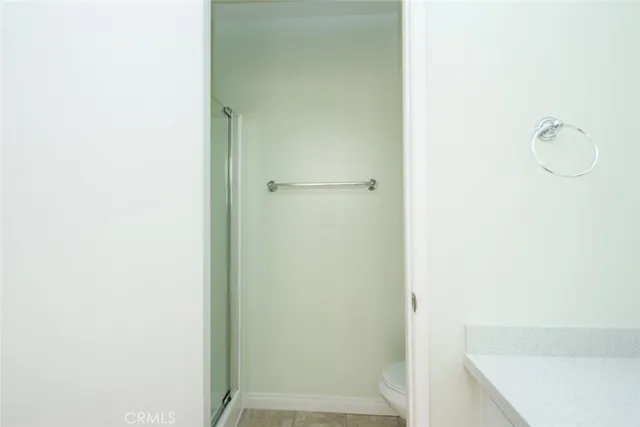 a bathroom with a glass shower door