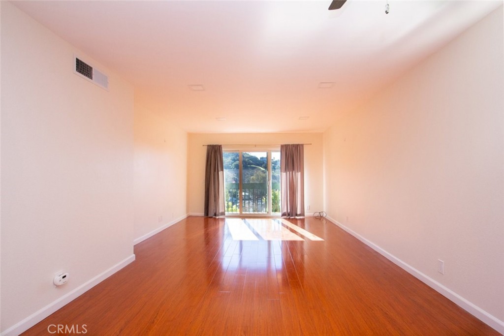 2940 North Verdugo Road, Unit 321 Glendale, CA 91208 - Photo 2 of 38 a view of an empty room with wooden floor and a window