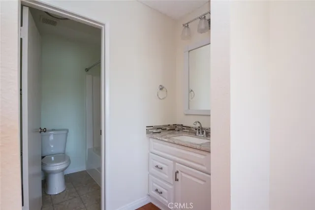 a white toilet sitting next to a shower