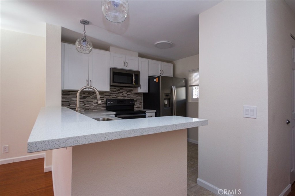 2940 North Verdugo Road, Unit 321 Glendale, CA 91208 - Photo 7 of 38 a kitchen with kitchen island a counter top space appliances and cabinets
