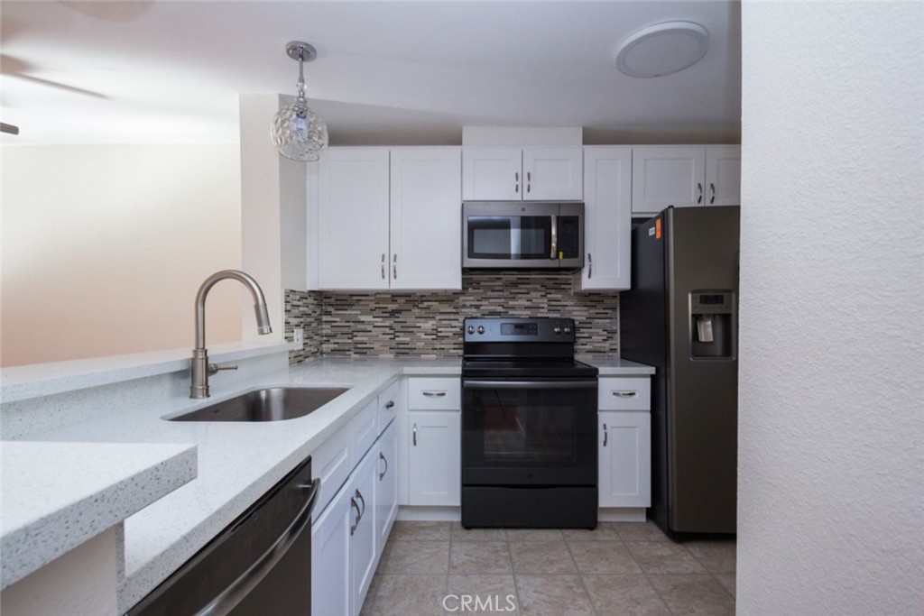 2940 North Verdugo Road, Unit 321 Glendale, CA 91208 - Photo 8 of 38 a kitchen with stainless steel appliances granite countertop a refrigerator and a sink