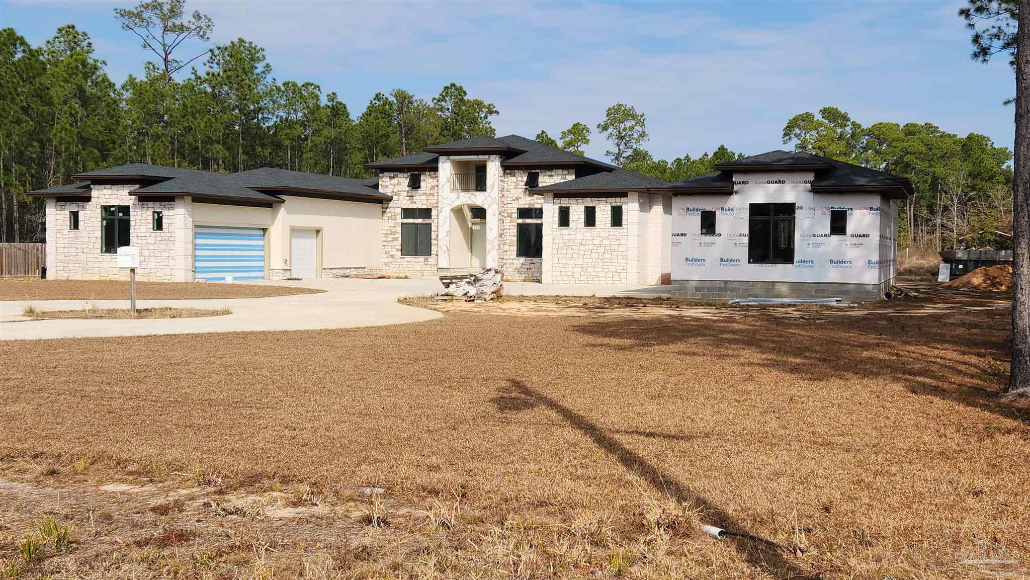 Pearson Road Milton, FL 32583 - Photo 3 of 3 a front view of a house with a yard and garage