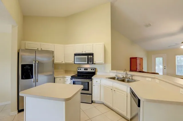 a kitchen with a sink stove and refrigerator