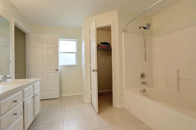 a bathroom with a bathtub and a shower
