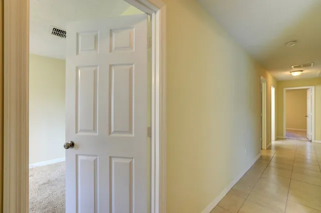 a view of a hallway with entryway door