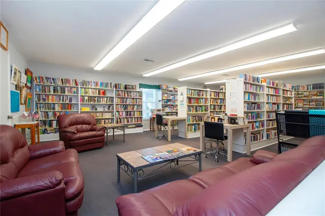 a view of a swimming pool with a patio and a yard