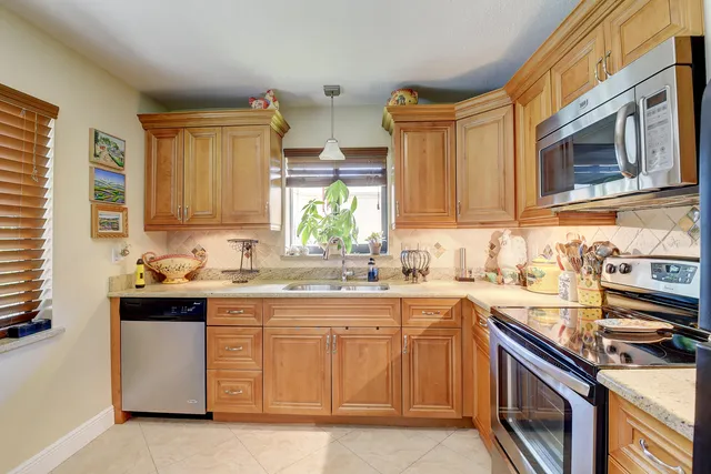 a kitchen with stainless steel appliances granite countertop a stove and a sink