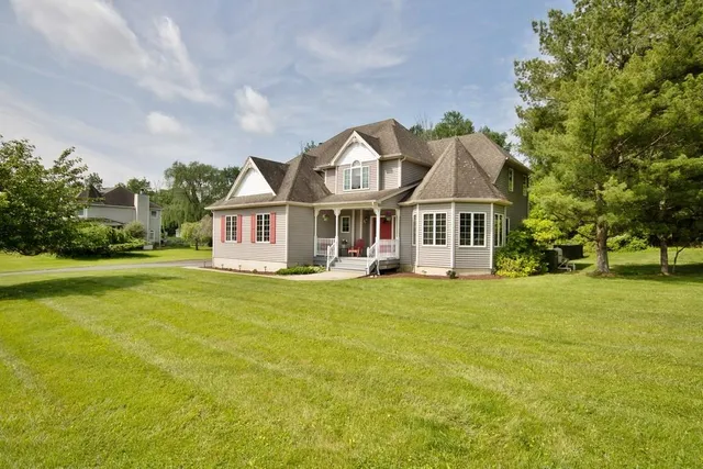 a front view of a house with a garden