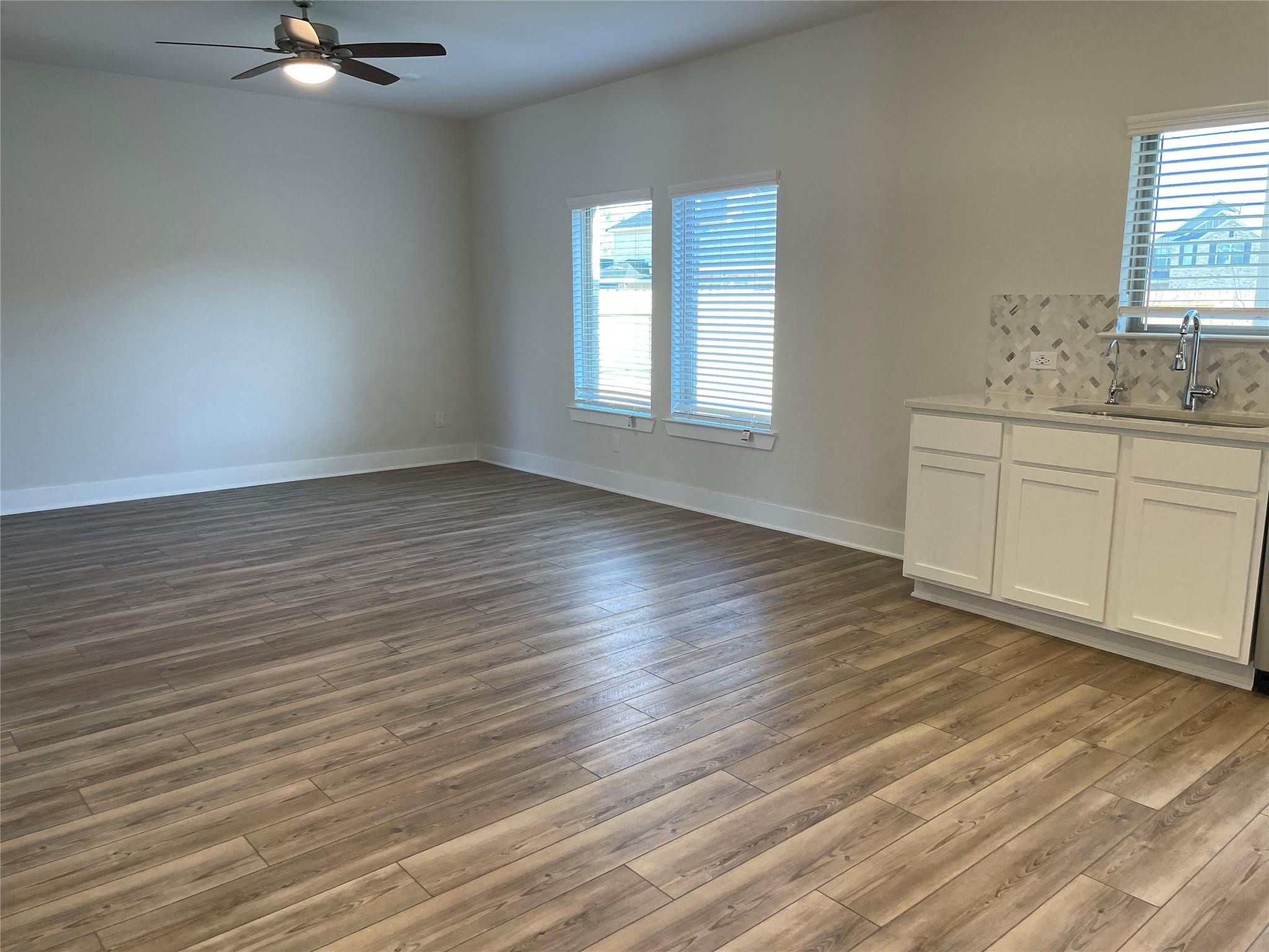 10638 Whitejacket Conroe, TX 77385 - Photo 13 of 25 wooden floor in an empty room with a window
