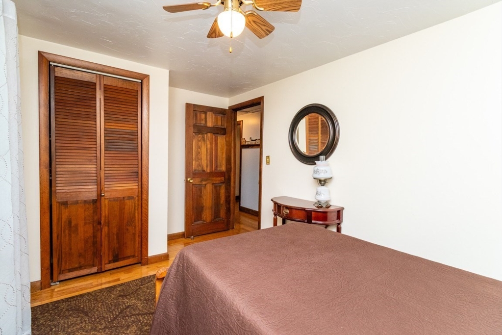 118 Bruce Road Walpole, MA 02081 - Photo 18 of 30 a bedroom with a large bed and a chandelier