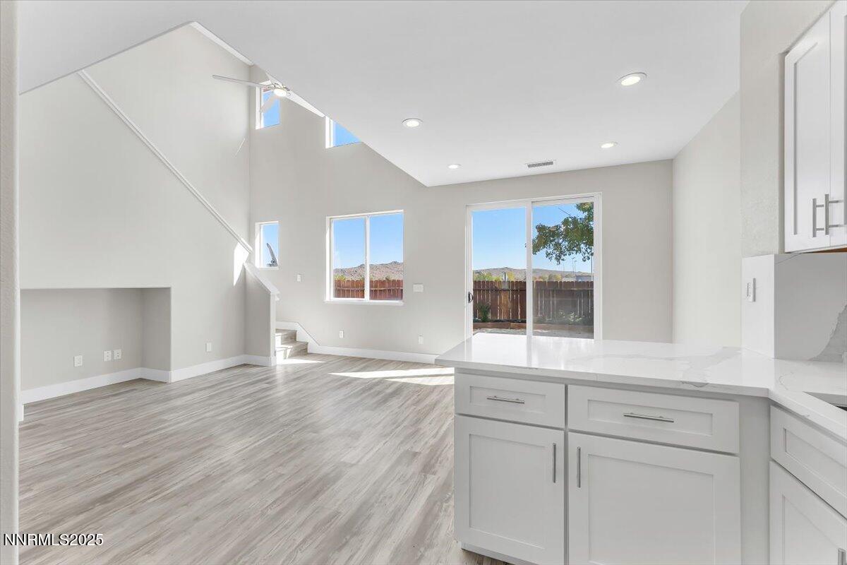 9252 Lone Wolf Circle Reno, NV 89506 - Photo 12 of 26 a view of an empty room with wooden floor and a window