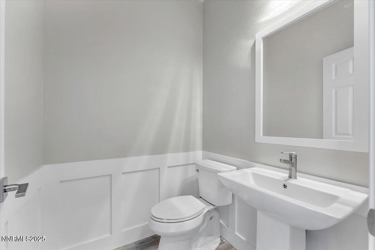 9252 Lone Wolf Circle Reno, NV 89506 - Photo 13 of 26 a bathroom with a sink a toilet and mirror