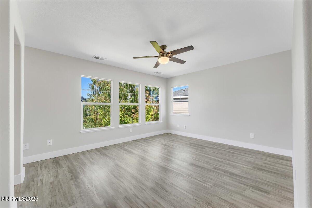 9252 Lone Wolf Circle Reno, NV 89506 - Photo 15 of 26 an empty room with wooden floor and windows