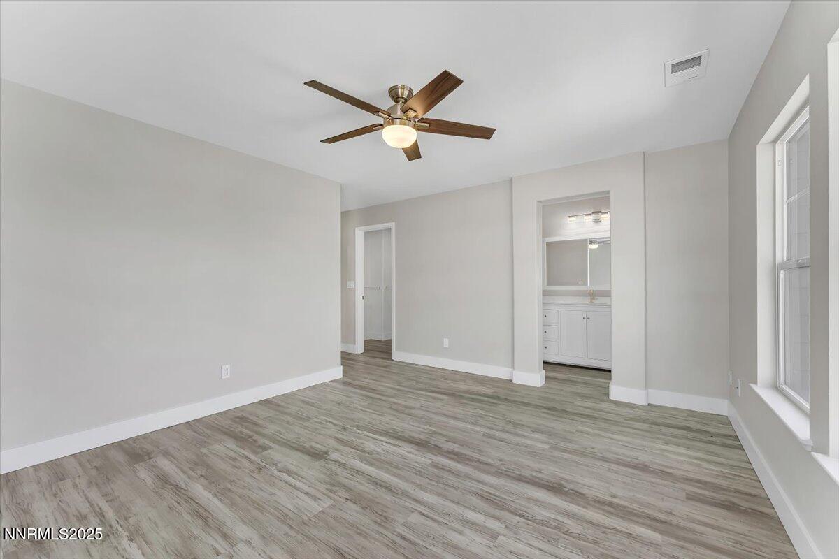 9252 Lone Wolf Circle Reno, NV 89506 - Photo 16 of 26 a view of empty room with wooden floor and fan