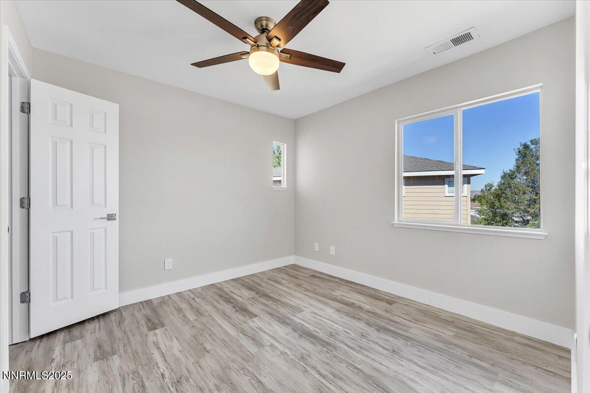9252 Lone Wolf Circle Reno, NV 89506 - Photo 21 of 26 wooden floor in an empty room with a window