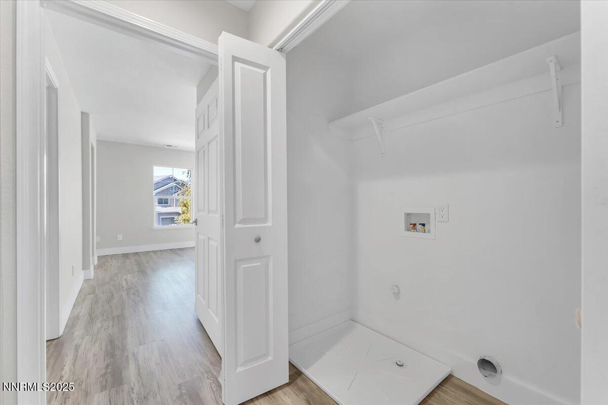 9252 Lone Wolf Circle Reno, NV 89506 - Photo 22 of 26 a view of a hallway with wooden floor