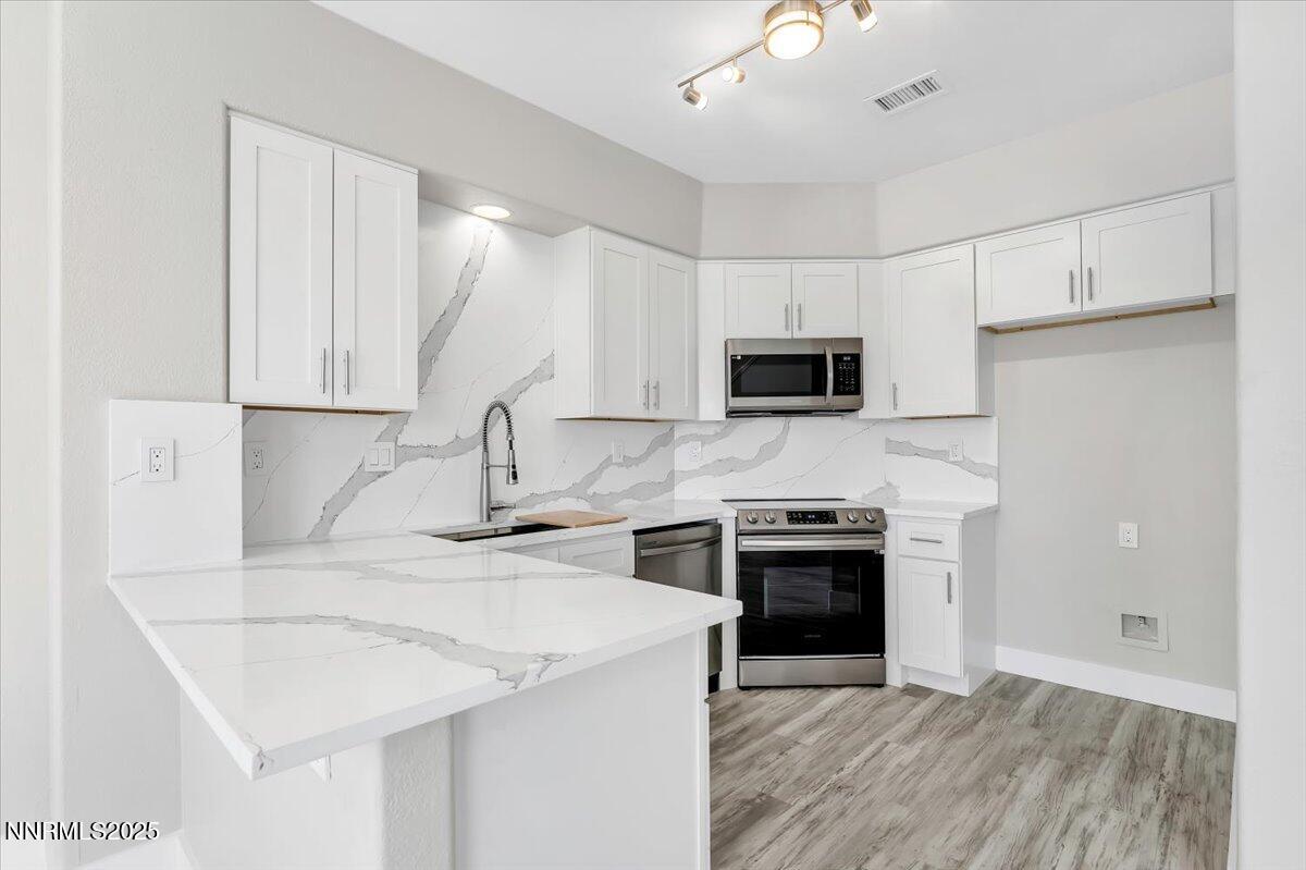 9252 Lone Wolf Circle Reno, NV 89506 - Photo 9 of 26 a kitchen with a sink a stove and refrigerator