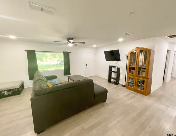 a living room with furniture and a flat screen tv