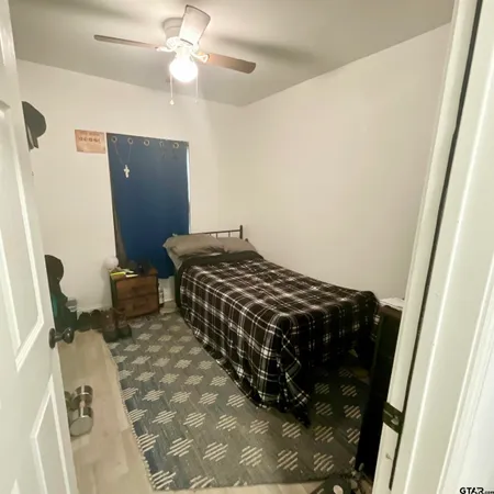 a blue bed sitting in a bedroom next to a bathroom
