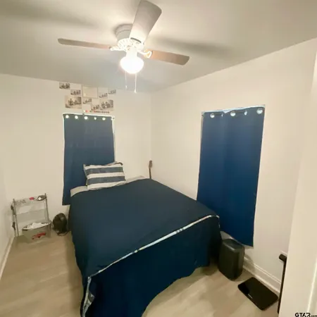 a bathroom with a double vanity sink mirror and bathtub