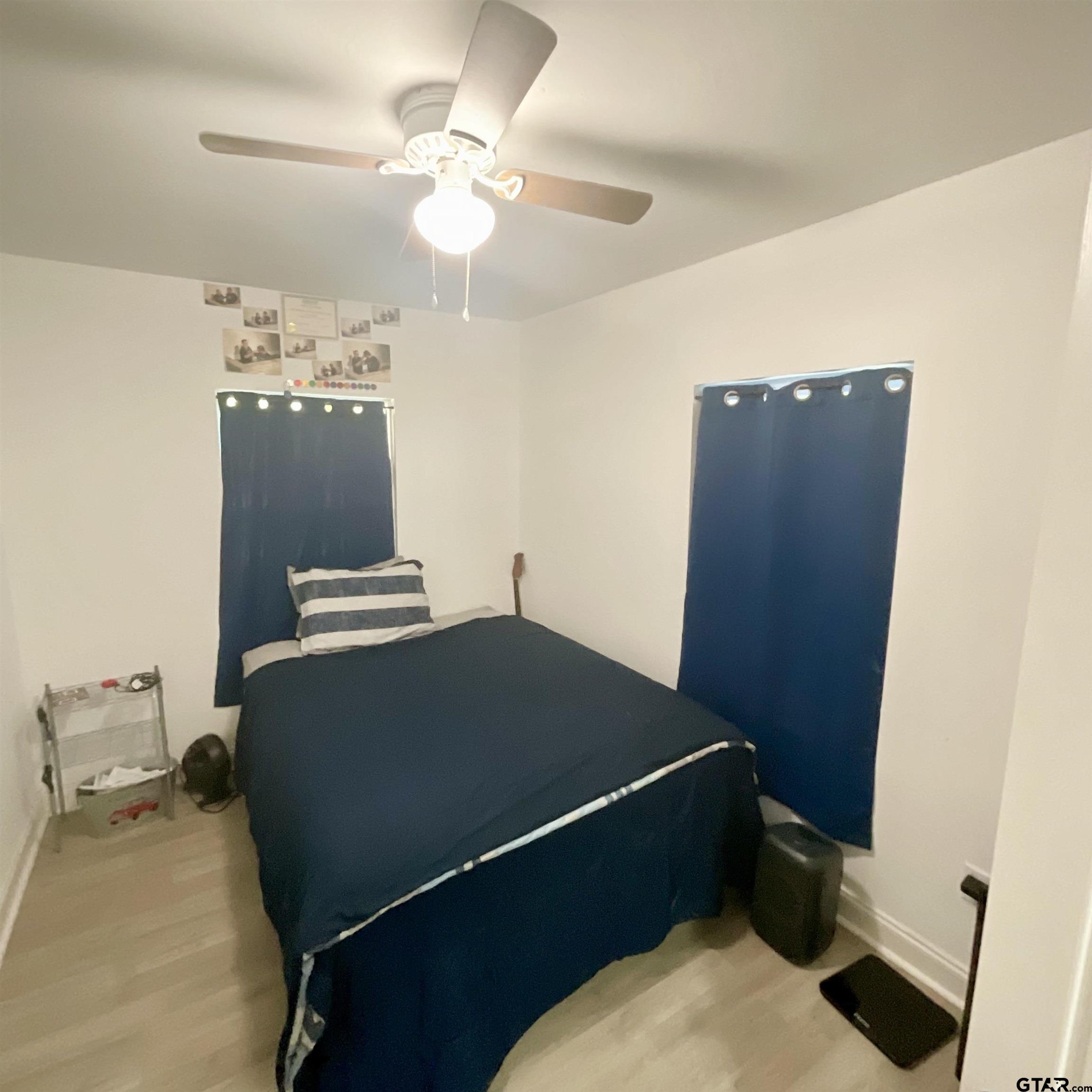 151 Patton Lane Tyler, TX 75704 - Photo 20 of 26 a blue bed sitting in a bedroom next to a bathroom