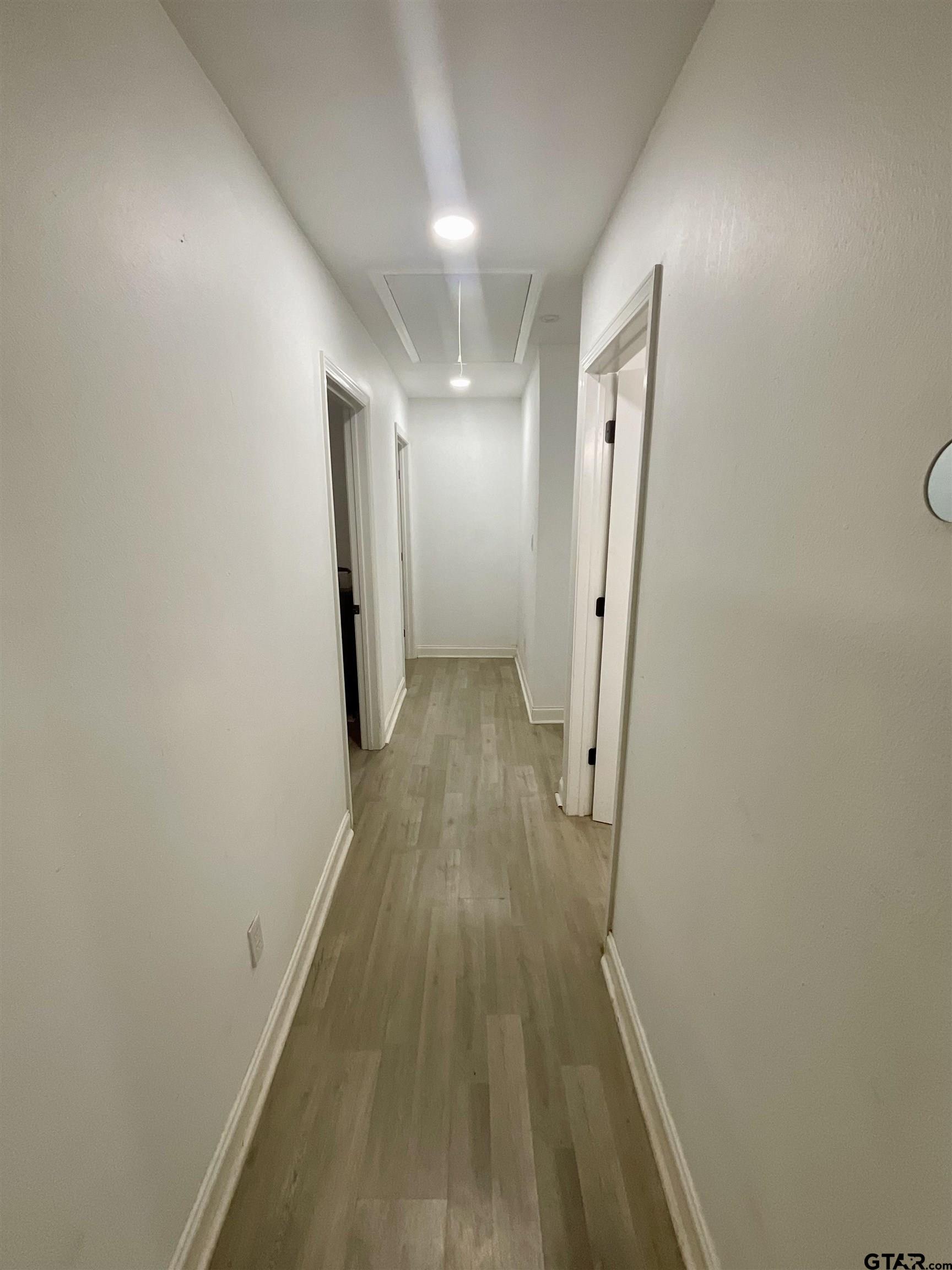 151 Patton Lane Tyler, TX 75704 - Photo 2 of 26 a view of a hallway with wooden floor