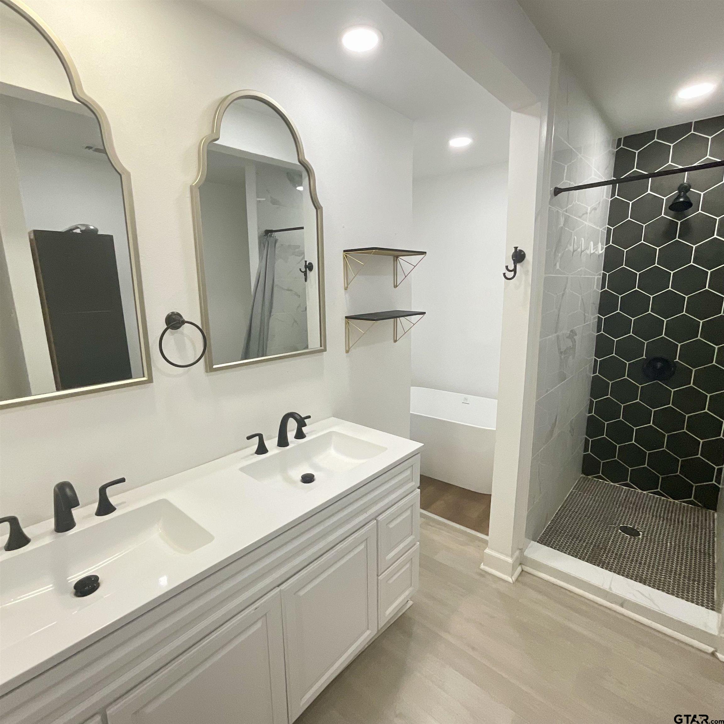 151 Patton Lane Tyler, TX 75704 - Photo 22 of 26 a bathroom with a double vanity sink mirror and shower
