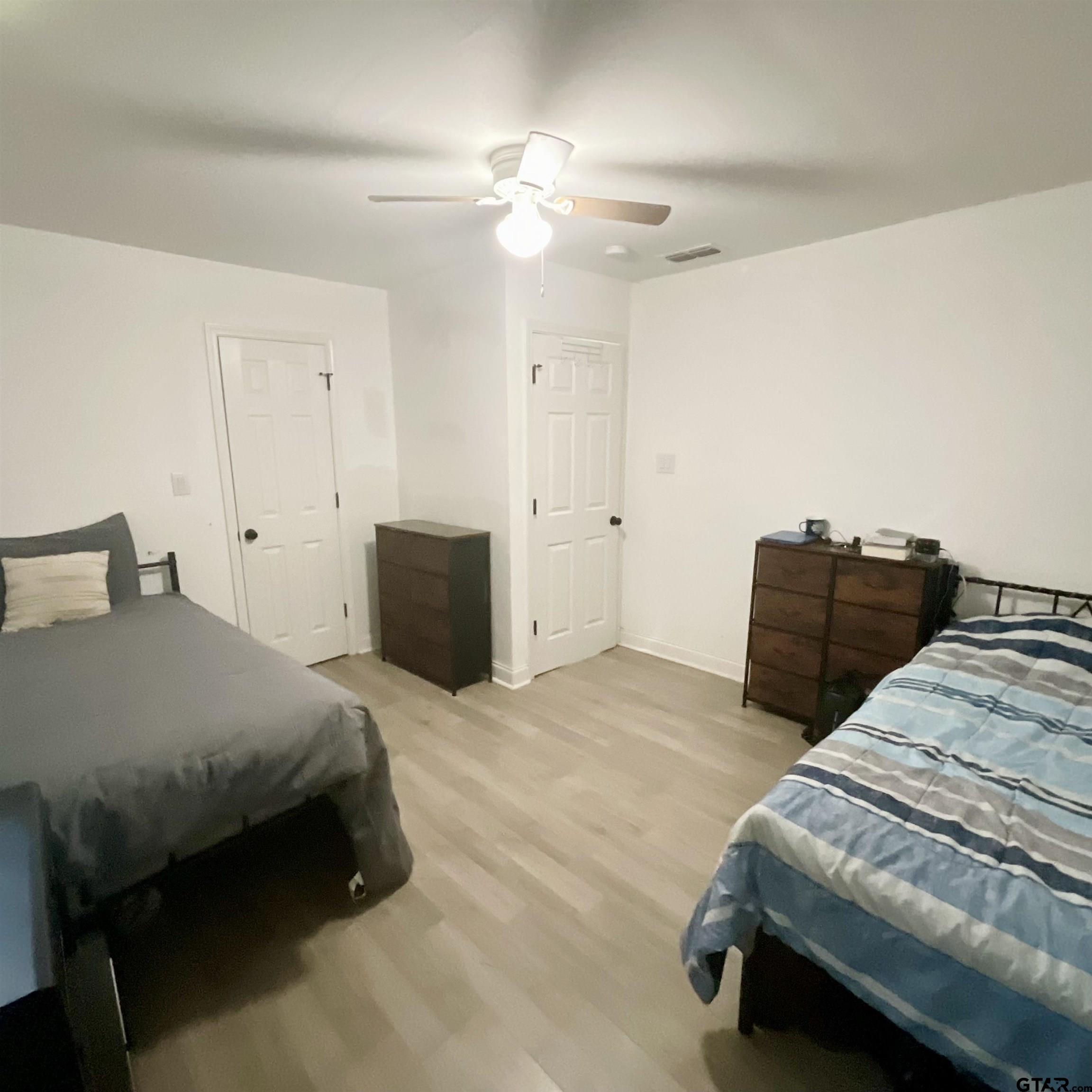151 Patton Lane Tyler, TX 75704 - Photo 3 of 26 a bedroom with bed and window