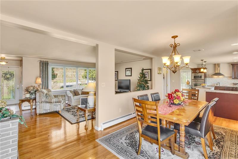 154 Bryson Road Gibsonia, PA 15044 - Photo 11 of 41 a dining room with wooden floor and a chandelier