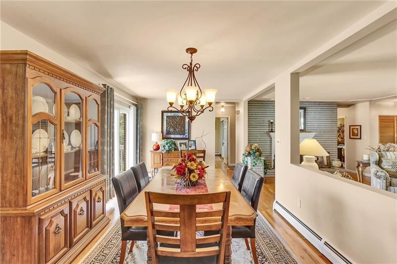 154 Bryson Road Gibsonia, PA 15044 - Photo 13 of 41 a view of a dining room with furniture a chandelier and wooden floor