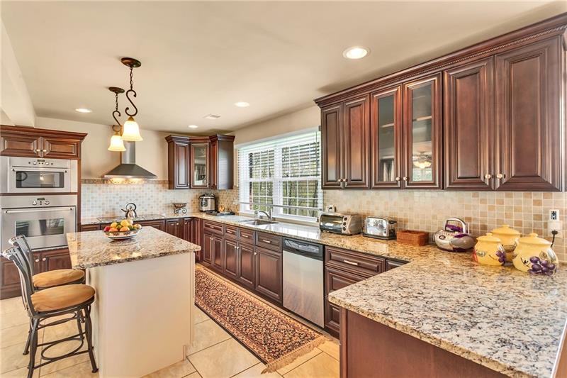 154 Bryson Road Gibsonia, PA 15044 - Photo 14 of 41 a kitchen with a sink and chairs