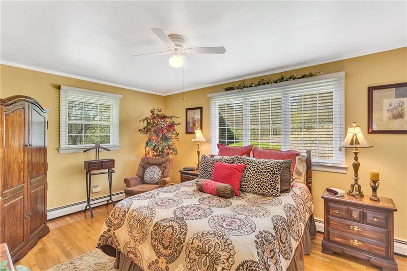 154 Bryson Road Gibsonia, PA 15044 - Photo 19 of 41 a bedroom with a bed and wooden floor